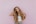 woman standing next to pink wall while scratching her head