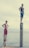 Two young people stand confidently on wooden posts by the water. One person in a black tank top and blue shorts is on a taller post, while the other in red shorts is on a shorter post. The sky is overcast, creating a calm atmosphere.