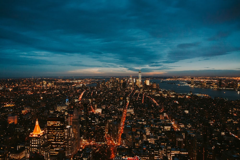 aerial photo of city near body of water during nighttime