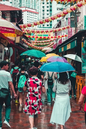 group of people walking at street with bazaar