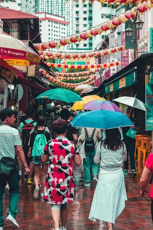 group of people walking at street with bazaar