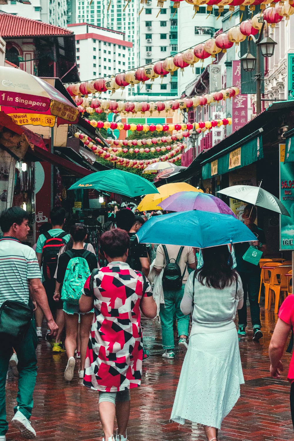 group of people walking at street with bazaar