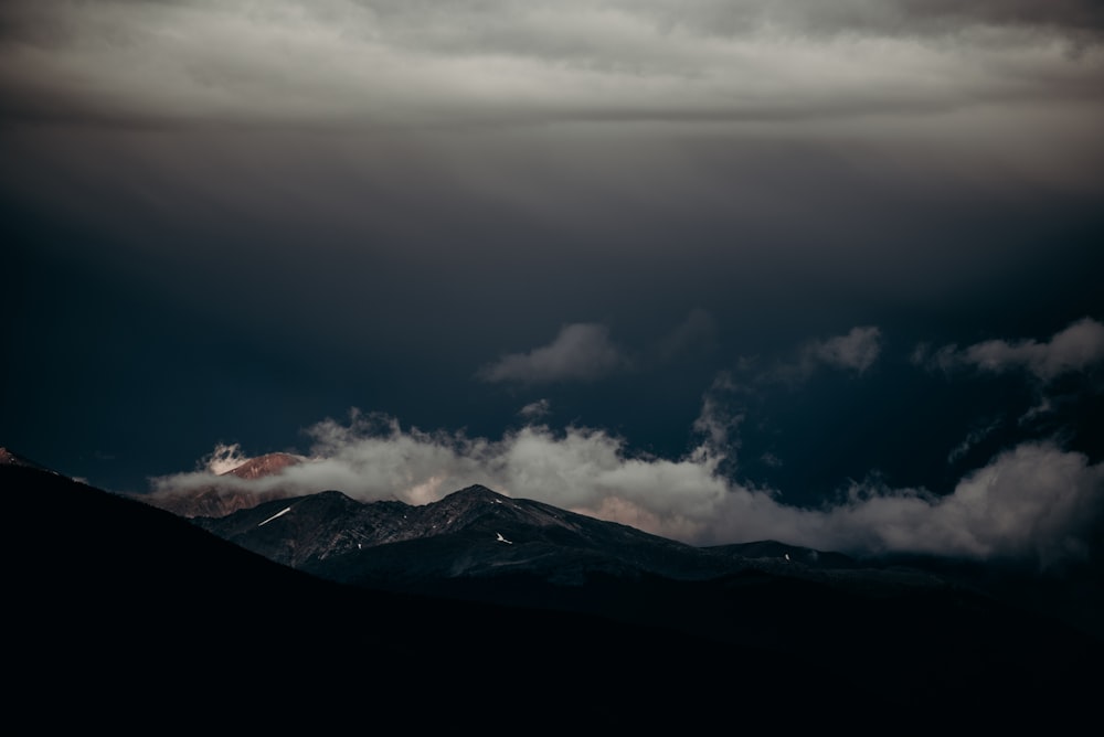 mountain covered with fog during daytime