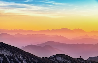 mountains under a rainbow sky