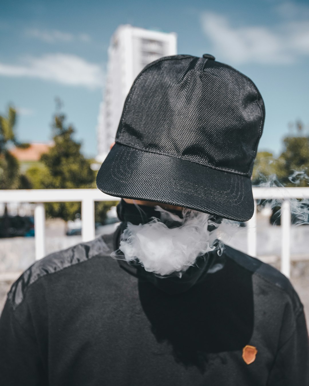 Hidden person exhaling smoke