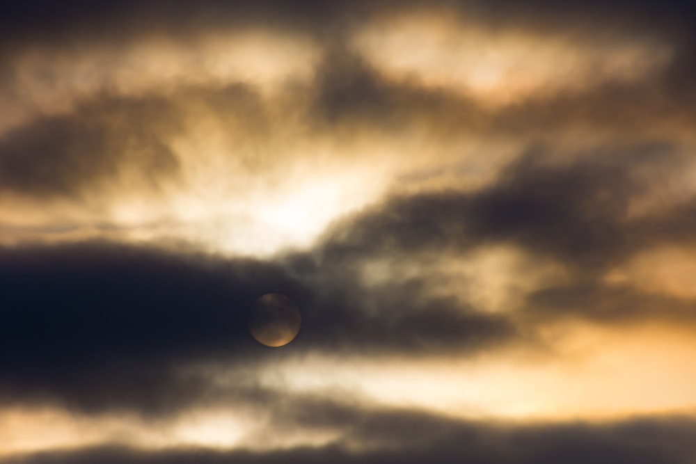 sun behind clouds during sunset