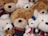 A cozy arrangement of colorful teddy bears and stuffed toys on a soft blanket.