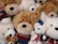 A cozy arrangement of colorful teddy bears and stuffed toys on a soft blanket.