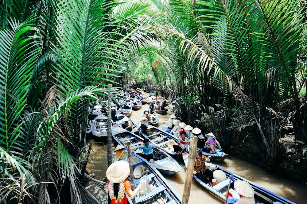 blue rowboat on body of water surrounded of trees