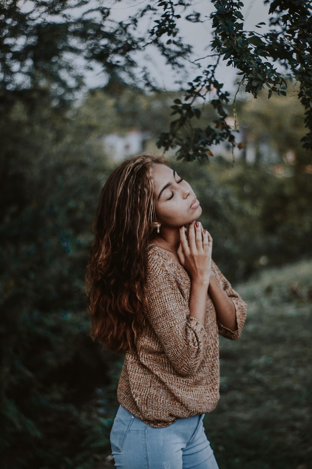 woman standing under the tree