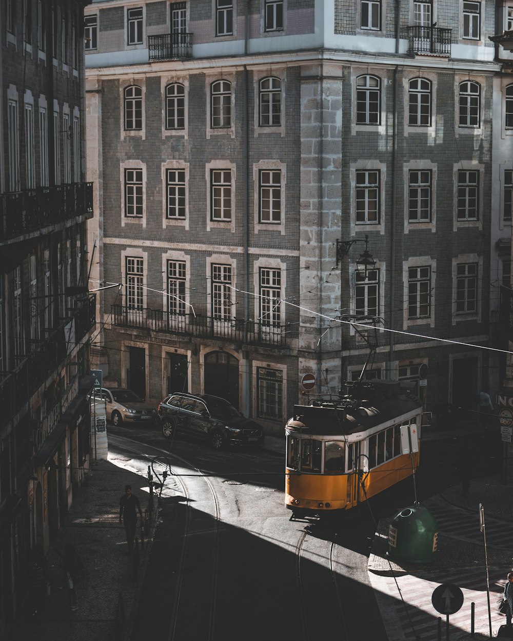 yellow tram roaming on street