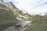 Overhead shot of Tata Sierra parked beside a mountain lake.