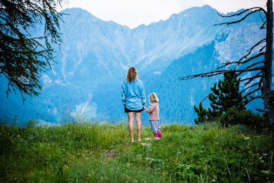 woman and child standing on mountain in Pozza di Fassa Italy