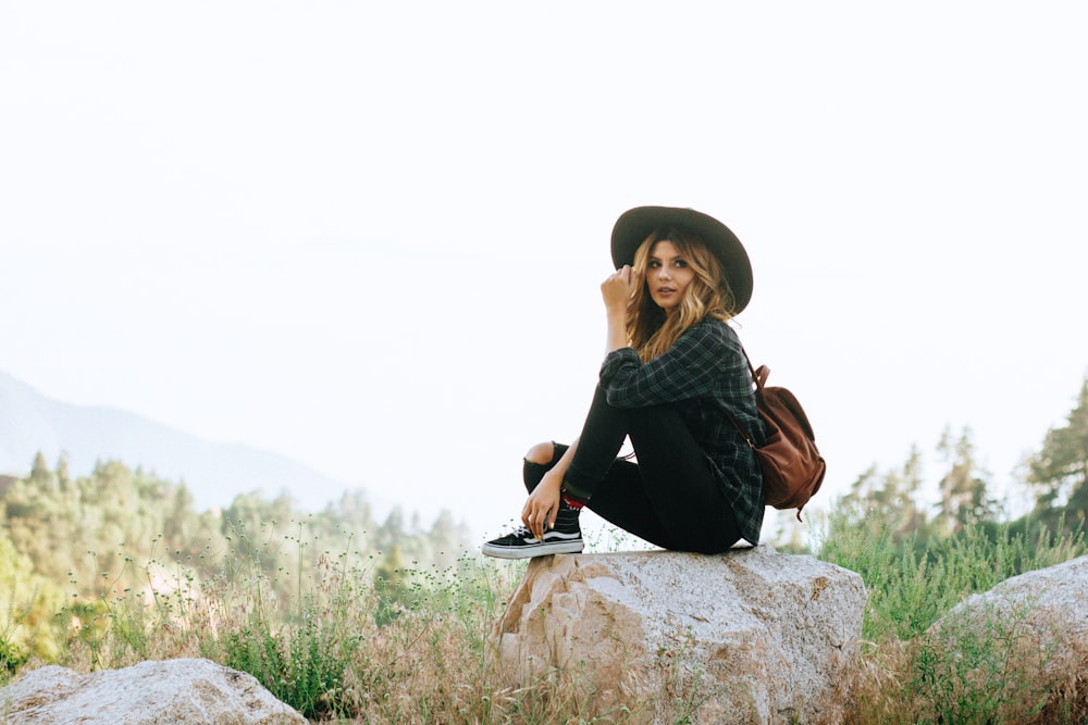 woman sitting on rock in forest