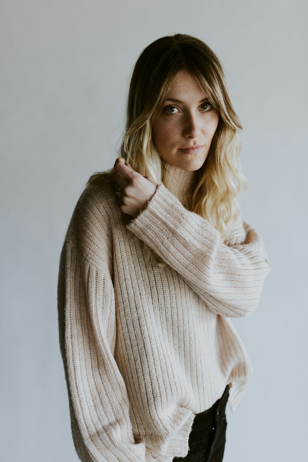 A portrait of a blonde woman wearing a sweater in Springfield