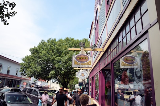 A vibrant storefront bustling with customers on a sunny day