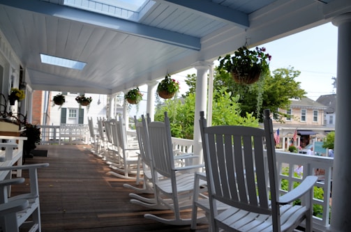View of a chalet porch with rocking chairs and flower pots