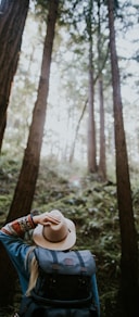 person wearing brown hat in forest