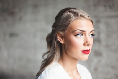 woman wearing white shirt with red lipstick radiant teams background