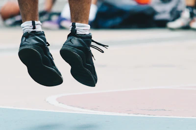Dynamic shot of an athlete mid-jump during a game, capturing motion and intensity.