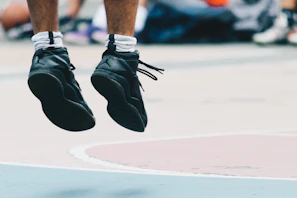 Athletes mid-jump during a box jump exercise, captured with dynamic motion and intense focus.