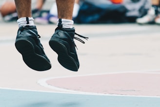 A close-up of an athlete's legs in motion, captured with motion-tracking technology against a blurred sports field background.