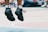 Close-up of a basketball player wearing shock-absorbing knee pads mid-jump on court.