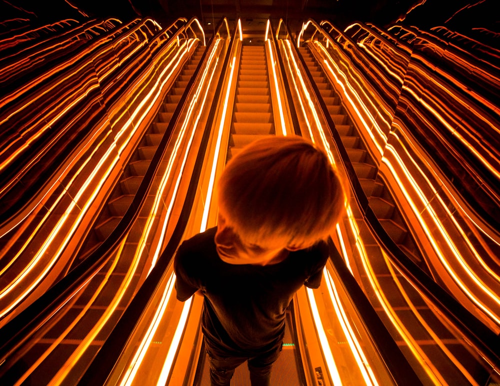 man on escalator with light