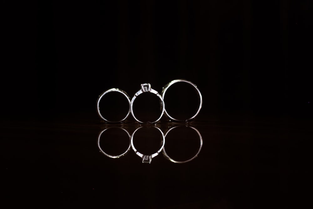 closeup photography of three silver-colored rings