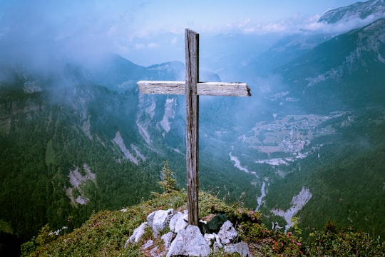 photo of brown wooden cross at cliff in Lac d'Anterne France