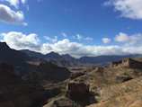 A panoramic view of Lesotho's high plateaus under a bright blue sky.