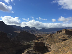 A panoramic view of Lesotho's high plateaus under a bright blue sky.
