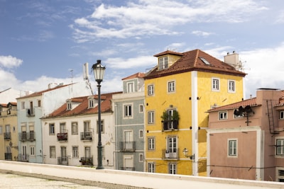 assorted-color building under cloudy blue sky during daytime