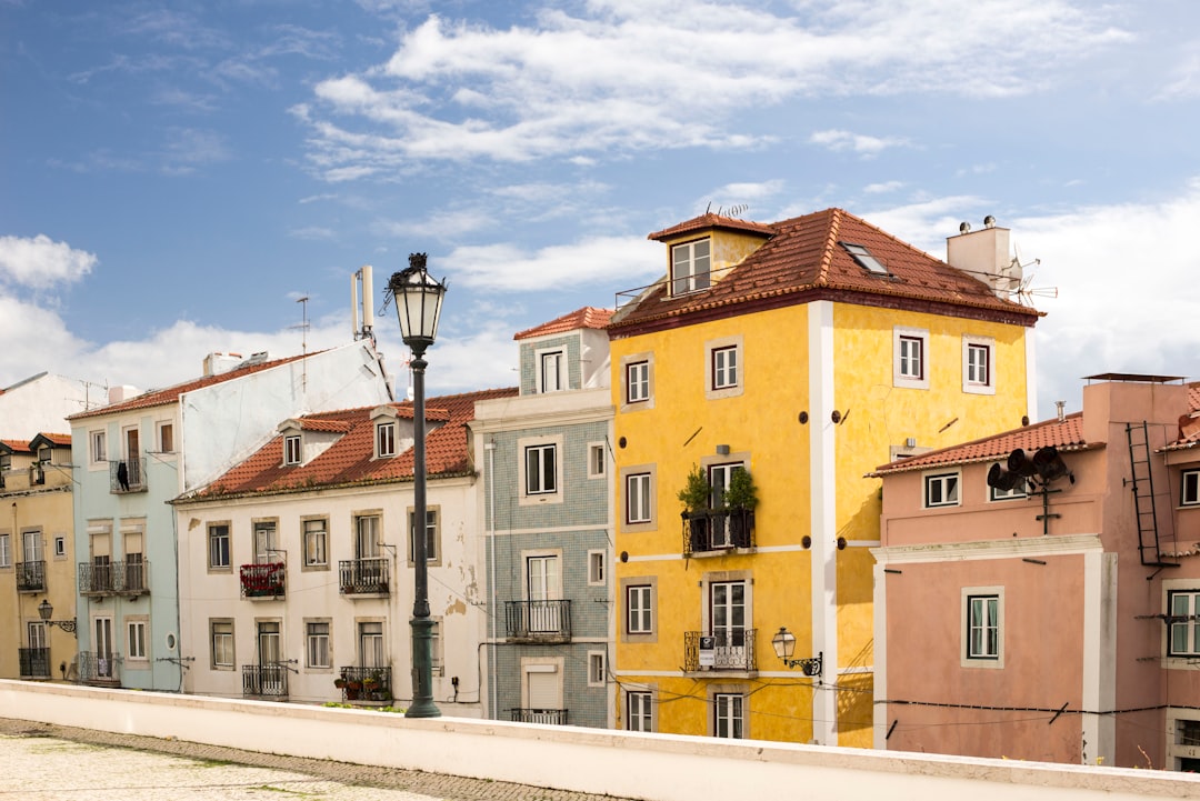 assorted-color building under cloudy blue sky during daytime