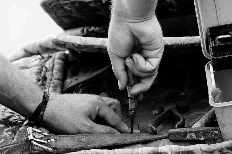 A craftsman using a hand tool for a repair project