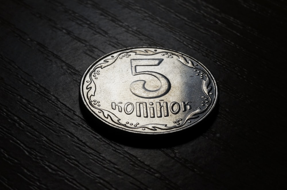 A silver coin that says "5 million."