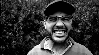 A vibrant photo of a person wearing a classic Aussie kangaroo cap outdoors.