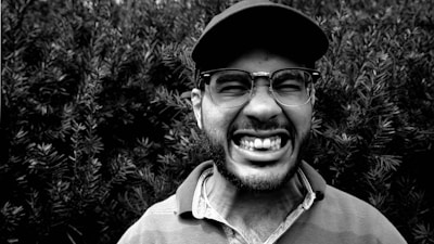 A vibrant photo of a person wearing a classic Aussie kangaroo cap outdoors.