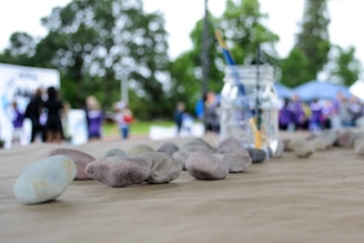Children and families gathered around a lapidary demonstration, watching stones being shaped and polished.