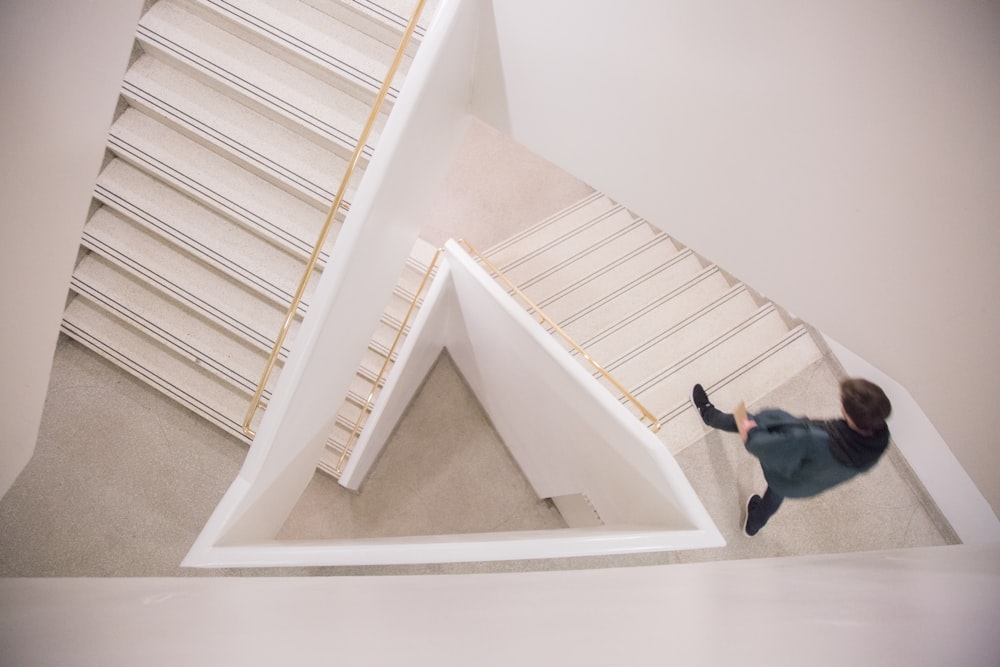 walking person on white concrete stairs