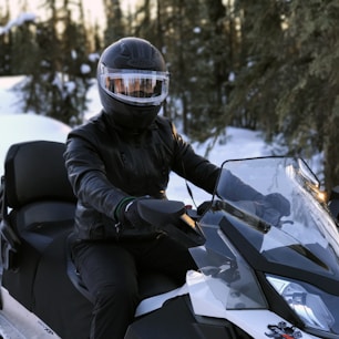 person riding on snowmobile