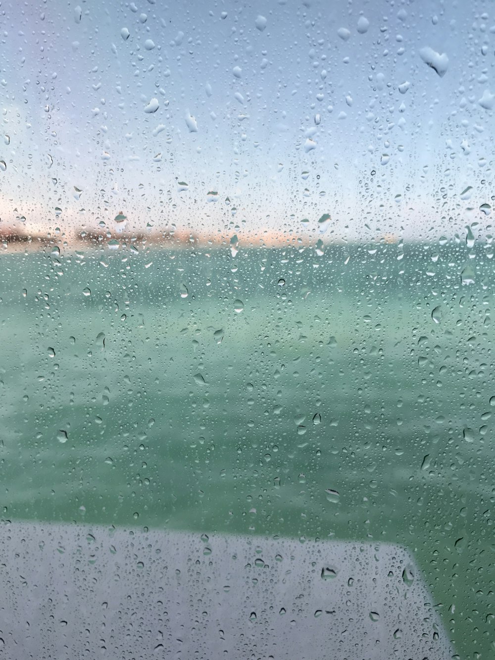 dewdrops on glass window selective-focus photography at daytime