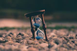 selective focus photo of brown and blue hourglass on stones