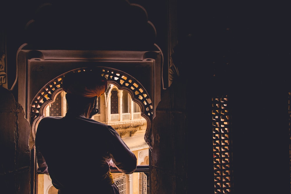 painting of man looking on window