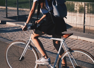 woman riding white rigid bike