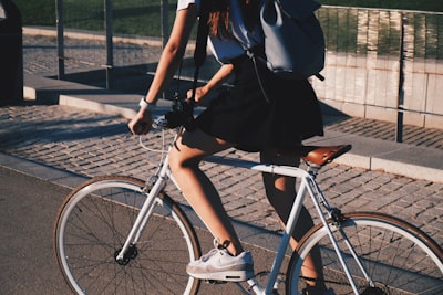 woman riding white rigid bike bike google meet background