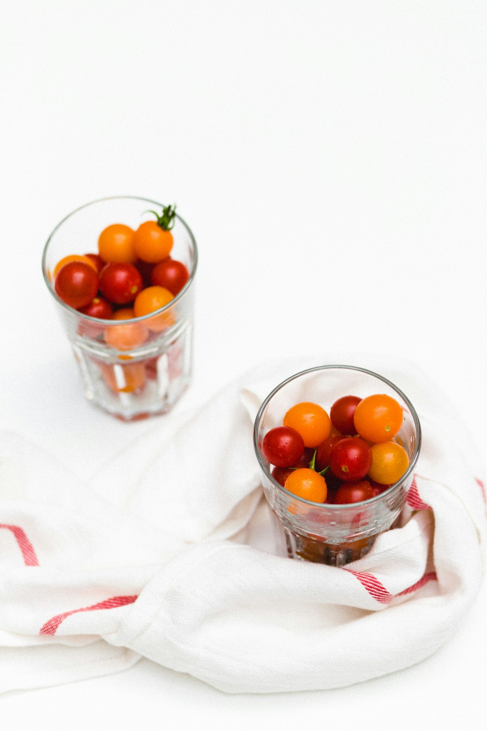 yellow and red tomatoes in glasses