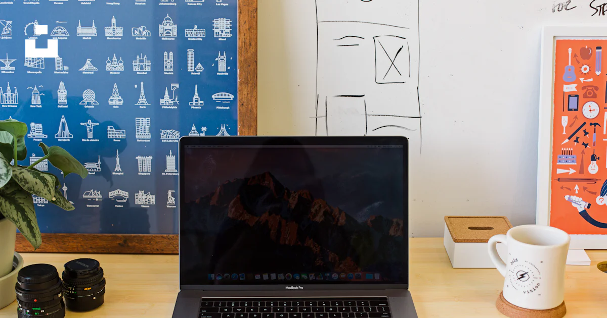 Macbook Pro on table near white mug and PRODUCT RED iPhone photo – Free ...