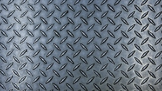a close up of a metal diamond plate
