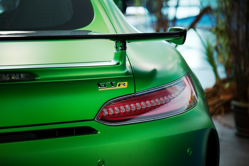The passenger side taillight of a green car.